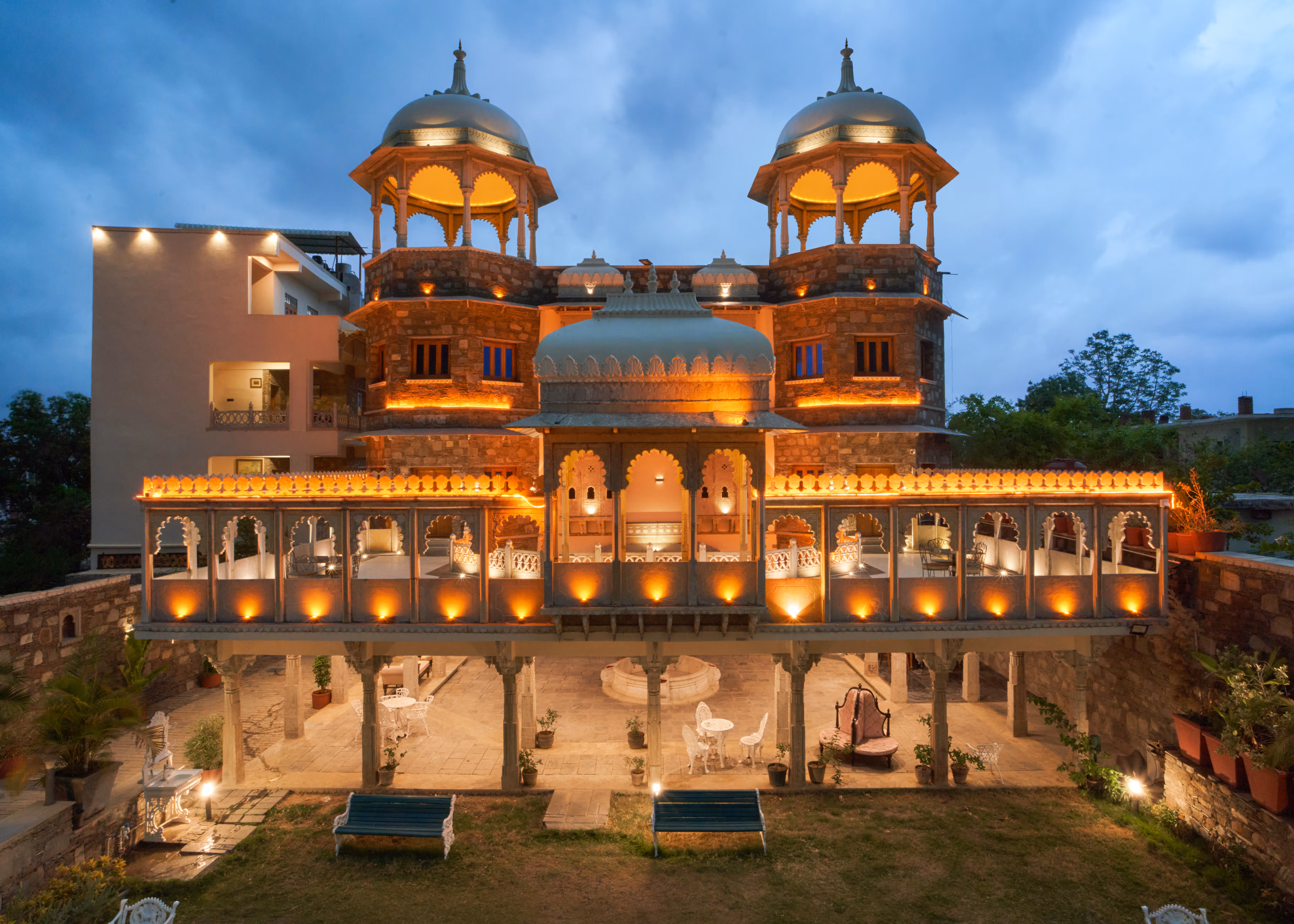 Front view of Shikargarh Palace with glowing arches, domed pavilions and a central entrance.